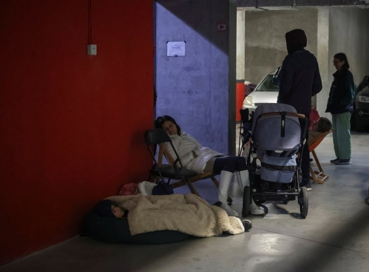 Lviv residents take shelter in underground parking garages during Russian airstrikes. (Photo: Reuters)